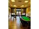 A spacious game room with a poker table, card tables, and elegant decor for entertainment at 3825 Quaint Ln # C, Clermont, FL 34711