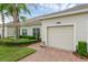 A well kept townhome showcasing a one car garage, walkway and manicured shrubs at 3825 Quaint Ln # C, Clermont, FL 34711