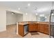 Open kitchen with stainless appliances, granite countertops, and tile flooring overlooking the living room at 3825 Quaint Ln # C, Clermont, FL 34711