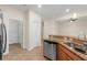 Open kitchen with stainless steel appliances, granite countertops, and tile flooring at 3825 Quaint Ln # C, Clermont, FL 34711
