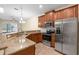 Kitchen features stainless steel appliances, granite countertops, and wood cabinets at 3825 Quaint Ln # C, Clermont, FL 34711