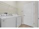Well-lit laundry room includes a washer, dryer, and wire shelving for additional storage at 3825 Quaint Ln # C, Clermont, FL 34711