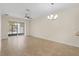 Bright living room with large sliding doors and fan at 3825 Quaint Ln # C, Clermont, FL 34711