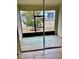 A screened lanai offers a view of the yard and a shaded outdoor space at 3825 Quaint Ln # C, Clermont, FL 34711