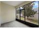 A bright sunroom with tile floors and large windows offering views of the landscaped backyard at 3825 Quaint Ln # C, Clermont, FL 34711