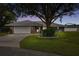 Single-story home with stone accents, two-car garage, and well-manicured lawn at 2106 Jonathan Ln, Winter Haven, FL 33884