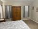 Main bedroom featuring neutral carpet, decorative window covers and an armoire at 2196 Kershaw Rd, The Villages, FL 32162