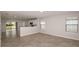 Spacious living room with tile flooring and a view into the kitchen at 5414 Sw 85Th Avenue Rd, Ocala, FL 34481