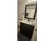 Bathroom with dark vanity and updated fixtures at 1640 Juno Trl # 202E, Astor, FL 32102