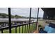 Enjoy water views from this screened balcony with comfy seating at 1640 Juno Trl # 202E, Astor, FL 32102