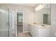 Bathroom with double vanity, a large mirror and a glass shower at 8323 Sw 52Nd Lane Rd, Ocala, FL 34481