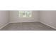 Simple carpeted bedroom with a window at 8323 Sw 52Nd Lane Rd, Ocala, FL 34481