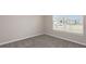 Simple bedroom with grey carpet and a large window at 8323 Sw 52Nd Lane Rd, Ocala, FL 34481