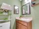 Stylish bathroom featuring a vanity with sink, a decorative mirror, and organized shelving at 901 Swann Dr, Lakeland, FL 33809