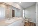 Bathroom features double sinks, a large mirror, and a shower with bright white tile at 9569 Sw 62Nd Ct, Ocala, FL 34476