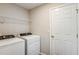 Bright laundry room featuring a washer, dryer, and wire shelving for optimal storage solutions at 9569 Sw 62Nd Ct, Ocala, FL 34476