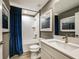 Clean bathroom with a tub, white vanity, and blue accents at 6013 Sw 96Th Pl, Ocala, FL 34476