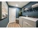 Convenient laundry room with washer, dryer, and shelving at 6013 Sw 96Th Pl, Ocala, FL 34476