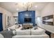 Living room with sectional sofa, blue accent wall, and modern chandelier at 6013 Sw 96Th Pl, Ocala, FL 34476