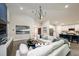 Spacious living area with sectional sofa, blue accent wall, and large artwork at 6013 Sw 96Th Pl, Ocala, FL 34476