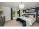 Spacious main bedroom with large windows and a navy blue accent wall at 6013 Sw 96Th Pl, Ocala, FL 34476
