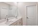 Bright bathroom featuring a double vanity with quartz countertop, white cabinets, and modern fixtures at 6062 Sw 97Th St, Ocala, FL 34476