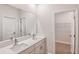 Modern bathroom boasting a double vanity with quartz countertop and a view into the closet at 6062 Sw 97Th St, Ocala, FL 34476