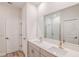 Elegant bathroom featuring a double vanity, quartz countertops, wood flooring, and a shower at 6062 Sw 97Th St, Ocala, FL 34476
