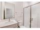 Modern bathroom with textured tile in the shower, glass door, and neutral vanity with sink at 6062 Sw 97Th St, Ocala, FL 34476