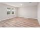 A bright and airy bedroom with two large windows and wood-look flooring at 6062 Sw 97Th St, Ocala, FL 34476
