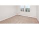 Bright bedroom featuring neutral carpet, base trim, and double-window natural light at 6062 Sw 97Th St, Ocala, FL 34476