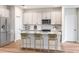 Bright kitchen features stainless steel appliances, modern white cabinetry, and quartz countertops at 6062 Sw 97Th St, Ocala, FL 34476