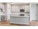 Modern kitchen with stainless steel appliances, gray cabinets and quartz countertops at 6062 Sw 97Th St, Ocala, FL 34476
