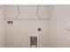 Bright laundry room featuring white walls, overhead shelving, and appliance hookups at 6062 Sw 97Th St, Ocala, FL 34476