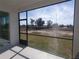 The screened porch offers an outdoor view of the open backyard, perfect for relaxing and enjoying the peaceful scenery at 6062 Sw 97Th St, Ocala, FL 34476
