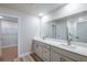 Bathroom showcasing double vanity with quartz counters and access to walk-in closet at 6074 Sw 97Th St, Ocala, FL 34476