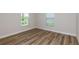 Cozy bedroom with wood flooring, natural light, and neutral-colored walls at 6074 Sw 97Th St, Ocala, FL 34476