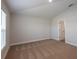 Empty bedroom with neutral carpet, natural light, and en-suite bathroom access at 6074 Sw 97Th St, Ocala, FL 34476