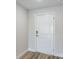 Clean and minimalist entryway with a white front door and modern hardware at 6074 Sw 97Th St, Ocala, FL 34476