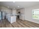 Modern kitchen featuring stainless steel appliances, quartz countertops, and wood flooring at 6074 Sw 97Th St, Ocala, FL 34476