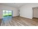 Living room with sliding glass doors offering scenic backyard and water views at 6074 Sw 97Th St, Ocala, FL 34476