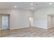 Spacious living room with neutral walls, wood floors, and multiple doorways at 6074 Sw 97Th St, Ocala, FL 34476