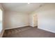 Spacious carpeted bedroom features natural light and neutral color palette at 6218 Sw 95Th Pl, Ocala, FL 34476