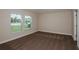 A simple bedroom with two windows and carpeting at 6218 Sw 95Th Pl, Ocala, FL 34476