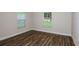 Cozy bedroom with wood flooring and a view of the outdoors through the window at 6218 Sw 95Th Pl, Ocala, FL 34476