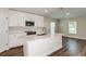 Modern kitchen features white cabinetry, stainless steel appliances, and a center island at 6218 Sw 95Th Pl, Ocala, FL 34476