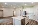 Open-concept living area with kitchen island and wood-look flooring at 6218 Sw 95Th Pl, Ocala, FL 34476