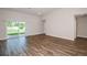 A bright room with wood flooring and sliding glass doors opening to the backyard at 6218 Sw 95Th Pl, Ocala, FL 34476