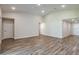 Spacious living room with wood-look flooring and neutral walls at 6218 Sw 95Th Pl, Ocala, FL 34476