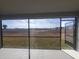 Screened patio with an open door and views of the community lawn at 6218 Sw 95Th Pl, Ocala, FL 34476